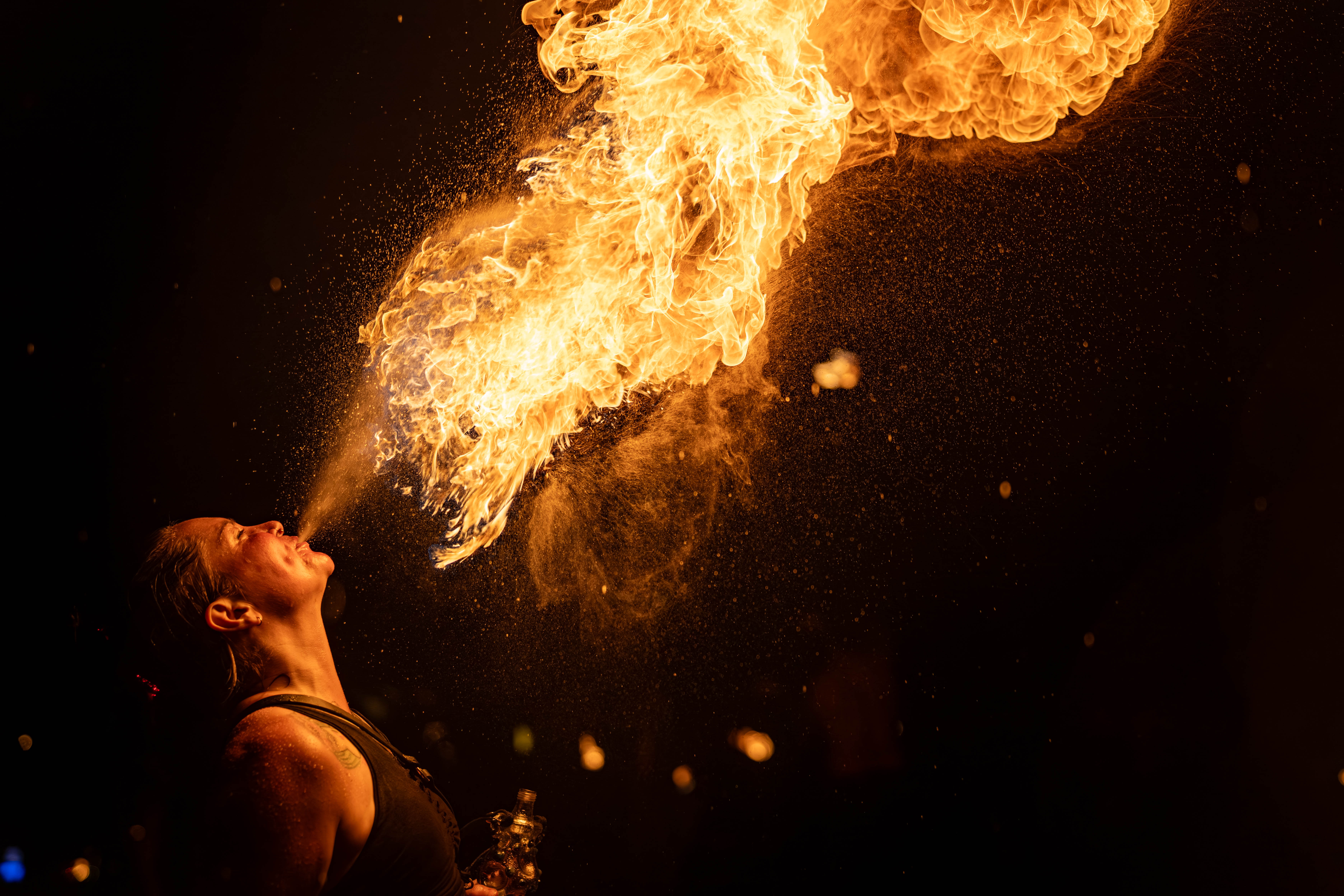 Fire breathing performance — dramatic flames against black sky